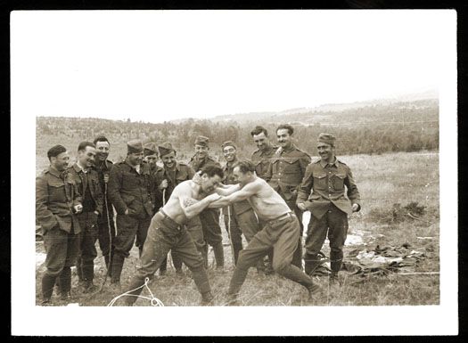 Two Jewish soldiers in the Slovak army wrestle while others look on
